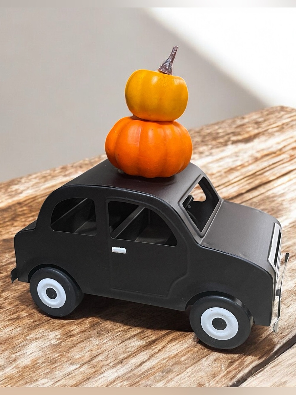Fall metal black car with stacked pumpkins on hood decoration